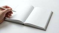 Hand turning blank white page of open book or notebook on white background for writing, reading, education and publishing projects.
