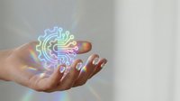 Female hand holding holographic digital circuit pattern with rainbow colors floating above palm against neutral background for technology concepts.