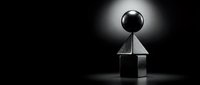Minimalist black sphere balanced on transparent glass cube with dramatic spotlight creating geometric shadows on dark background for modern design concepts.