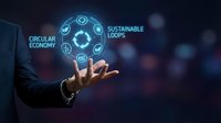 Businessman holding glowing holographic sphere with circular economy and sustainable loops icons, representing eco-friendly business solutions and green technology innovation.