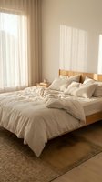 Serene bedroom interior with wooden bed frame, cream linens, and natural light streaming through sheer curtains, perfect for home decor and lifestyle design projects.