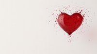 Red heart shape with paint splatter effect on white background, romantic artistic expression with droplets and splatters creating dynamic movement and texture.