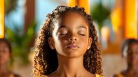 Young African American girl with curly natural hair and closed eyes in peaceful meditation pose against warm glowing background, expressing serenity and mindfulness.