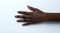 Close-up of open hand with dark skin tone on white background, suitable for healthcare, wellness, diversity, and medical educational materials.