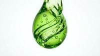 Green liquid drop with dynamic swirls and bubbles isolated on white background for eco-friendly design projects and natural product concepts.