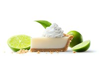 Slice of key lime pie with whipped cream garnished with fresh lime and mint leaf on white background, graham cracker crust visible. Dessert photography.
