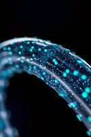 Glowing turquoise dots and particles flow through transparent curved tubes against dark background, creating futuristic technology visualization for network concepts.