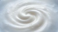 Creamy white swirl texture with smooth flowing curves creating elegant spiral pattern for dairy product packaging and culinary design projects.