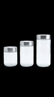 Three clear glass storage jars with metallic silver lids isolated on transparent background, ready for clipart, sublimation, print-on-demand designs, t-shirt graphics, and sticker applications.