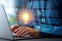 Business professional using laptop with glowing lightbulb and digital interface icons representing innovation, creativity and technology solutions.
