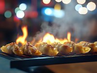 Steaming hot dumplings on grill with flames and bokeh lights in background, close-up view of Asian street food cooking process with dramatic lighting.