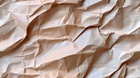 Crumpled beige paper background with rough texture and diagonal folds creating abstract pattern of light and shadows. Natural recycled material surface.