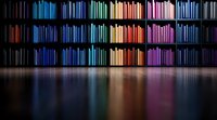 Colorful books arranged by spectrum colors on black shelves creating rainbow effect with reflection on glossy floor. Modern library interior design concept.