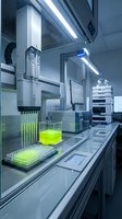 Modern automated laboratory equipment with robotic arm dispensing green liquid sample into microplate for scientific research and pharmaceutical testing.