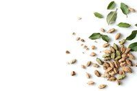 Fresh pistachios scattered with green leaves on white background, overhead view. Isolated nuts composition for food photography and commercial design projects.