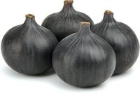 Fresh black garlic bulbs with dark fermented cloves for gourmet cooking and culinary applications on white background.