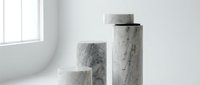 Elegant white marble cylindrical pedestals in minimalist bathroom interior with natural lighting for luxury product display and modern home decor.