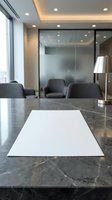 Modern office conference room with blank white paper on marble table for business presentations and corporate meetings.