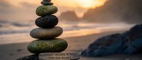 Balanced stone cairn stack on beach at golden sunset with motivational quote about harmony and wellness for meditation and mindfulness practices.