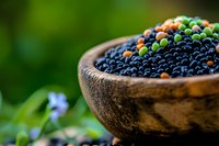 Fresh organic blueberries in rustic wooden bowl on natural green background. Healthy antioxidant superfood for nutrition and wellness lifestyle concepts.