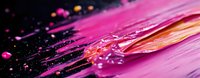 Vibrant pink and orange paint strokes with splashes and drops on black background create dynamic abstract composition with rich texture and flowing movement.