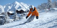 Skier in bright orange jacket carving down pristine snow slope with snow-covered mountain peaks and alpine chalets in background. Winter sports adventure.