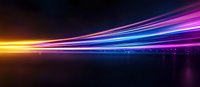 Colorful light trails streak across dark background creating dynamic motion effect with neon yellow, pink, purple and blue glowing lines reflecting on surface.