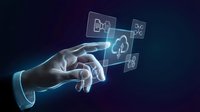 Businessman hand touching holographic cloud computing icons with digital technology interface on dark background for modern business solutions.