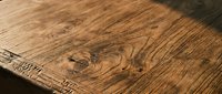 Rustic wooden surface with natural grain patterns and warm brown tones, showcasing aged wood texture suitable for interior design, flooring, and background projects.