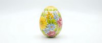 Colorful floral painted Easter egg with spring flowers including roses and daisies on white background, holiday decoration for seasonal celebrations.