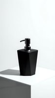Modern black soap dispenser on white surface with minimalist shadow casting, contemporary bathroom accessory for hygiene and cleanliness concepts.