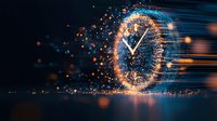 Digital clock face dissolving into glowing particles with motion blur effect against dark background, orange and blue light trails creating futuristic time concept.
