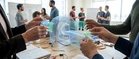 Business professionals analyzing holographic data visualization during corporate meeting with digital technology interface for strategic planning.