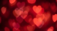 Romantic red heart-shaped bokeh lights creating dreamy Valentine's Day background for love-themed designs and wedding decorations.