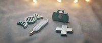 Medical icons set with DNA helix, test tube, doctor bag, and cross symbol arranged on gray surface with bokeh lights, healthcare concept.