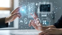 Business professionals interacting with futuristic holographic interface displaying data analytics, charts and digital technology elements in modern office.