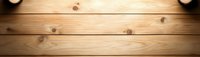 Rustic wooden planks background with dramatic spotlight illumination creating warm atmospheric glow on natural pine wood texture surface.