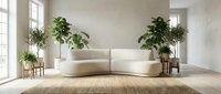 Modern minimalist living room with curved cream sofa, potted green plants, wooden side tables, and natural light from large windows on beige carpet.