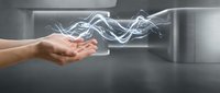 Hand releasing flowing white energy waves in modern kitchen interior with steam or smoke effects for wellness and spiritual concepts.