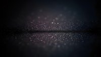 Dark glittery surface with sparkling particles and bokeh lights creating magical atmosphere for luxury backgrounds and elegant design projects.