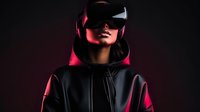 Young Asian woman wearing virtual reality headset in dark room with dramatic red lighting, dressed in black hoodie, futuristic technology concept.