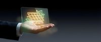 Businessman hand holding glowing holographic shopping cart with eco leaf symbol representing sustainable e-commerce and green online retail technology.
