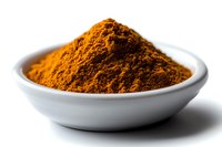 Ground turmeric powder in white ceramic bowl against white background, bright orange spice with rich texture and natural healing properties for cooking and wellness.