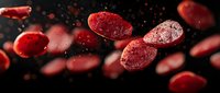 Red blood cells floating in plasma against dark background with dramatic lighting and depth of field effect, medical science visualization concept.