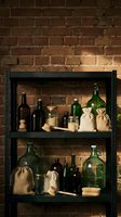 Vintage glass bottles and eco-friendly supplies on industrial shelves against exposed brick wall for sustainable living and zero waste lifestyle.