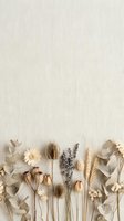 Dried flowers and eucalyptus leaves arranged on neutral linen background creating natural botanical flat lay composition for spa and wellness designs.