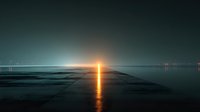 Serene ocean sunset with golden sun reflection creating luminous path across calm water surface under twilight sky for meditation and relaxation concepts.