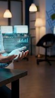 Businessman hands interacting with futuristic holographic interface displaying policy data and analytics charts in modern office environment.