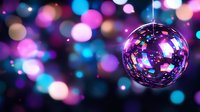 Shiny disco ball reflecting colorful bokeh lights in nightclub atmosphere with pink, purple and blue blurred background creating festive party mood.