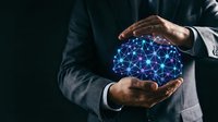 Businessman in formal suit holding glowing blue digital network globe with connected nodes, representing global connectivity, data technology, and business innovation on dark background.